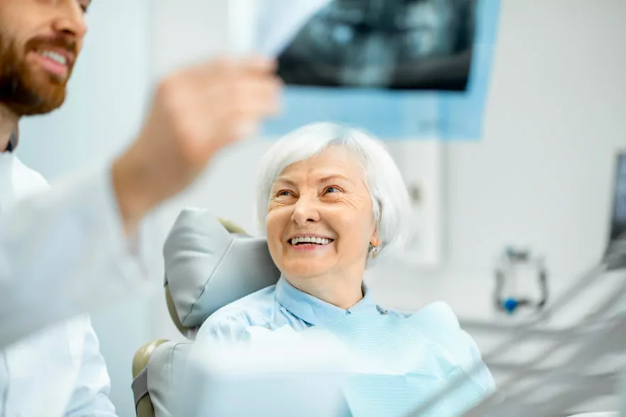 Dentist Showing Dental X-ray To The Patient In Houston, TX